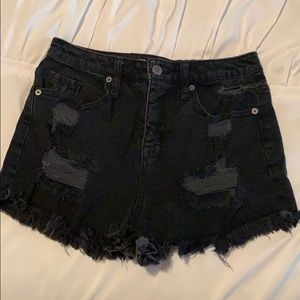 High waisted black distressed shorts.